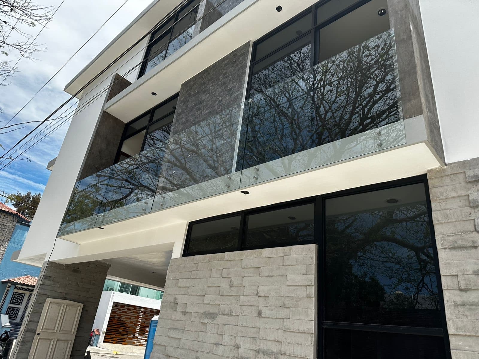 Fachada residencial con cristal y aluminio oscuro